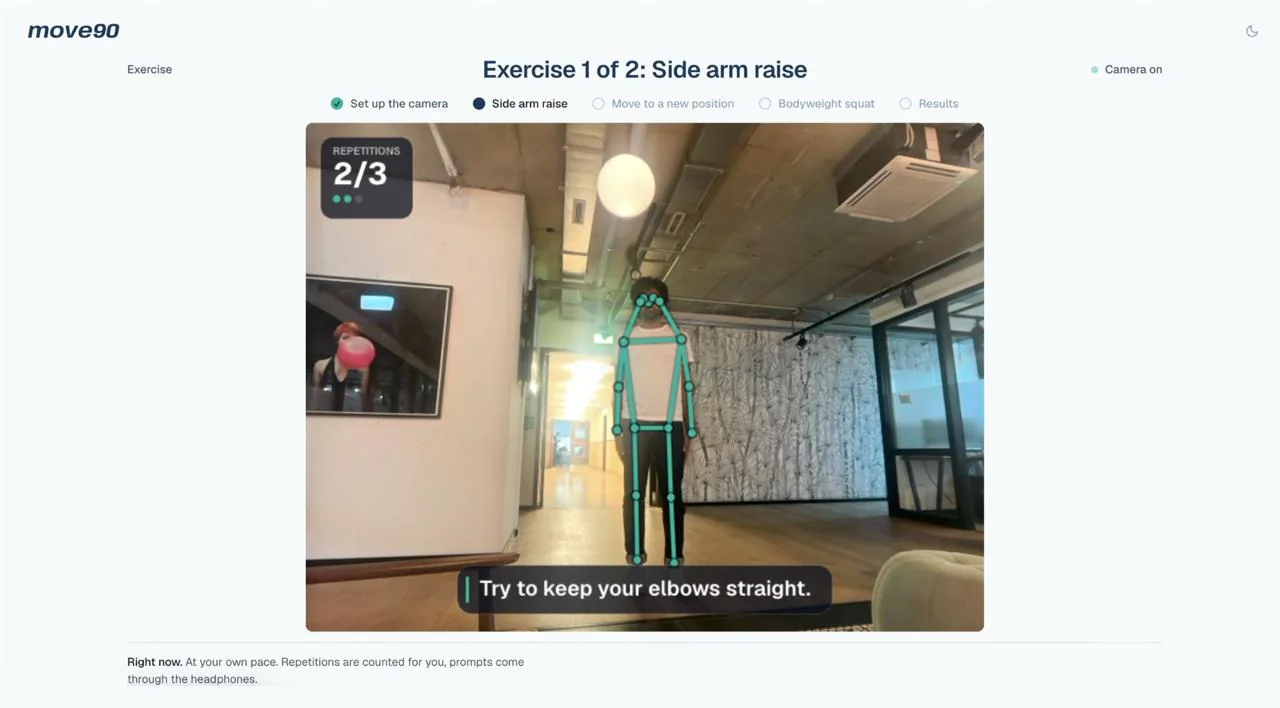A move90 exercise session on a MacBook: the camera counts repetitions of a side arm raise and prompts the patient to keep their elbows straight